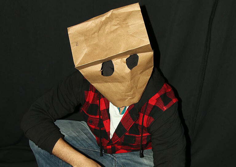 Crezno performing with a paper bag over his head