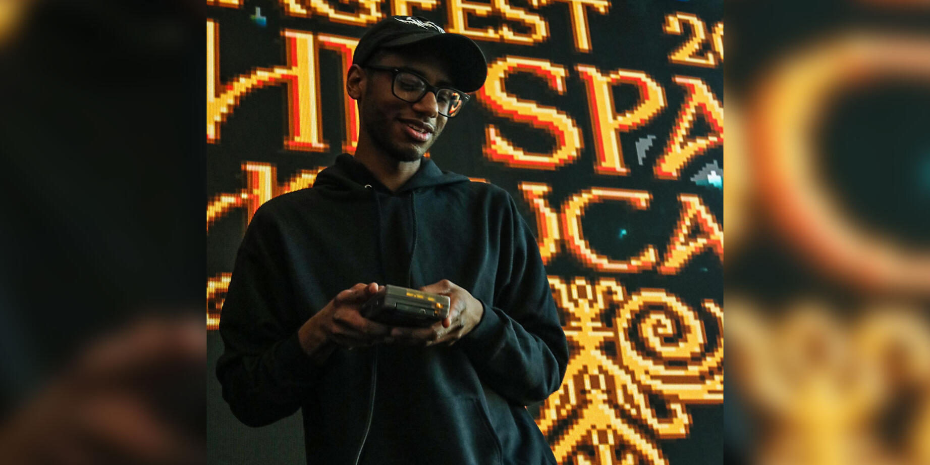 Mega Flare playing a gameboy on stage